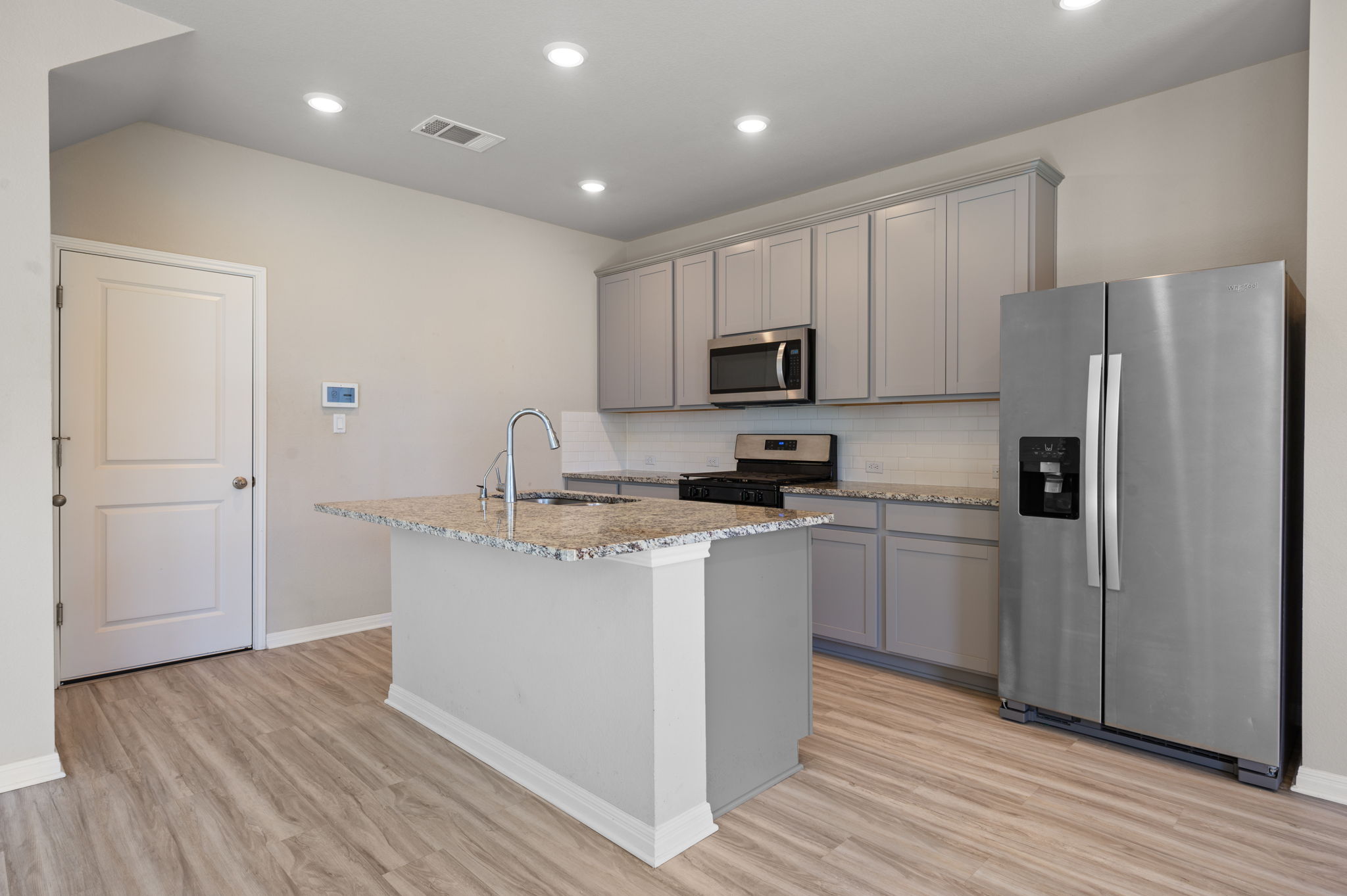 529 View Drive Georgetown, TX 78628 - Photo 5 of 20 Kitchen featuring stainless steel appliances, light stone countertops, gray cabinets, light wood finished floors, and recessed lighting