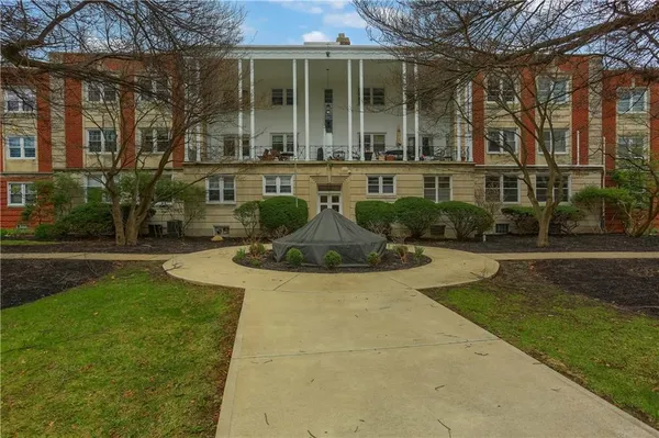 front view of house with a yard and potted plants