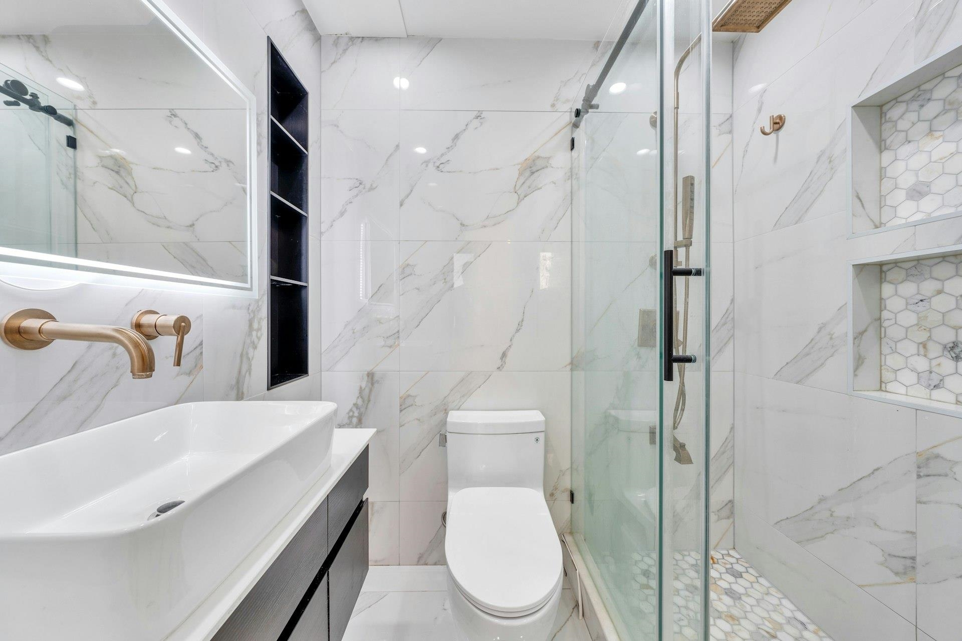 202 48th Street, Unit 3 Union City, NJ 07087 - Photo 13 of 17 a bathroom with a sink toilet and shower