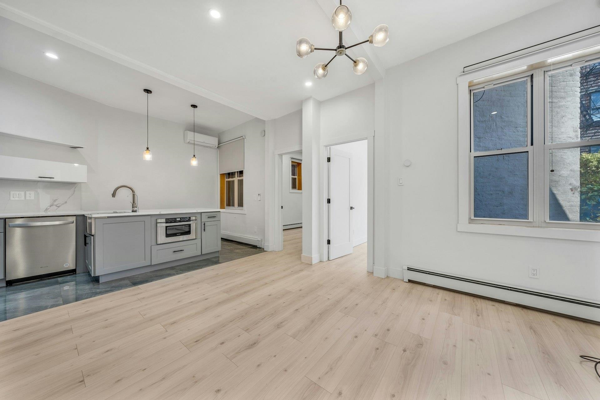 202 48th Street, Unit 3 Union City, NJ 07087 - Photo 15 of 17 a view of a kitchen with a sink and a window