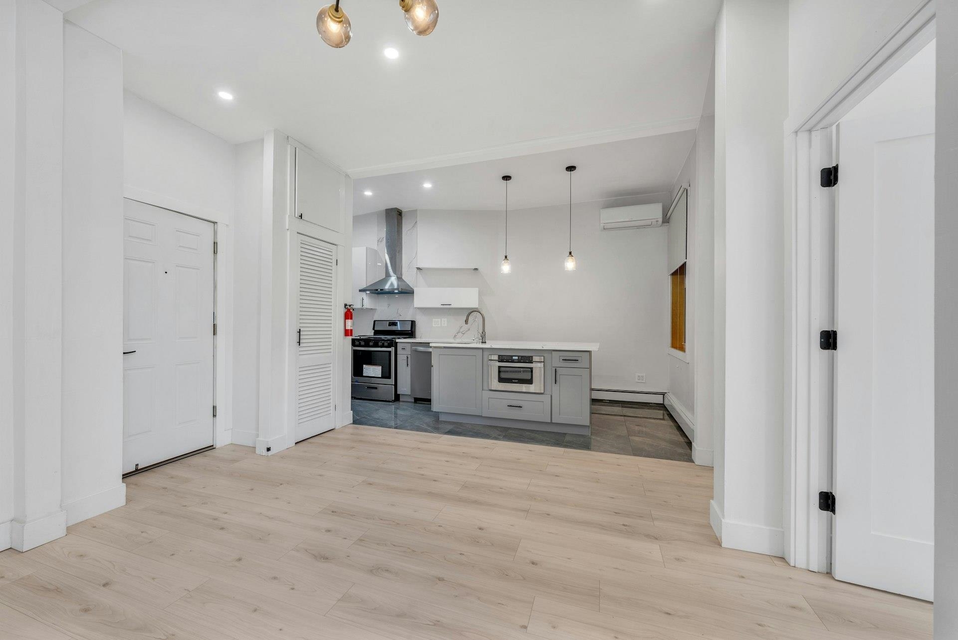 202 48th Street, Unit 3 Union City, NJ 07087 - Photo 3 of 17 a view of kitchen with wooden floor