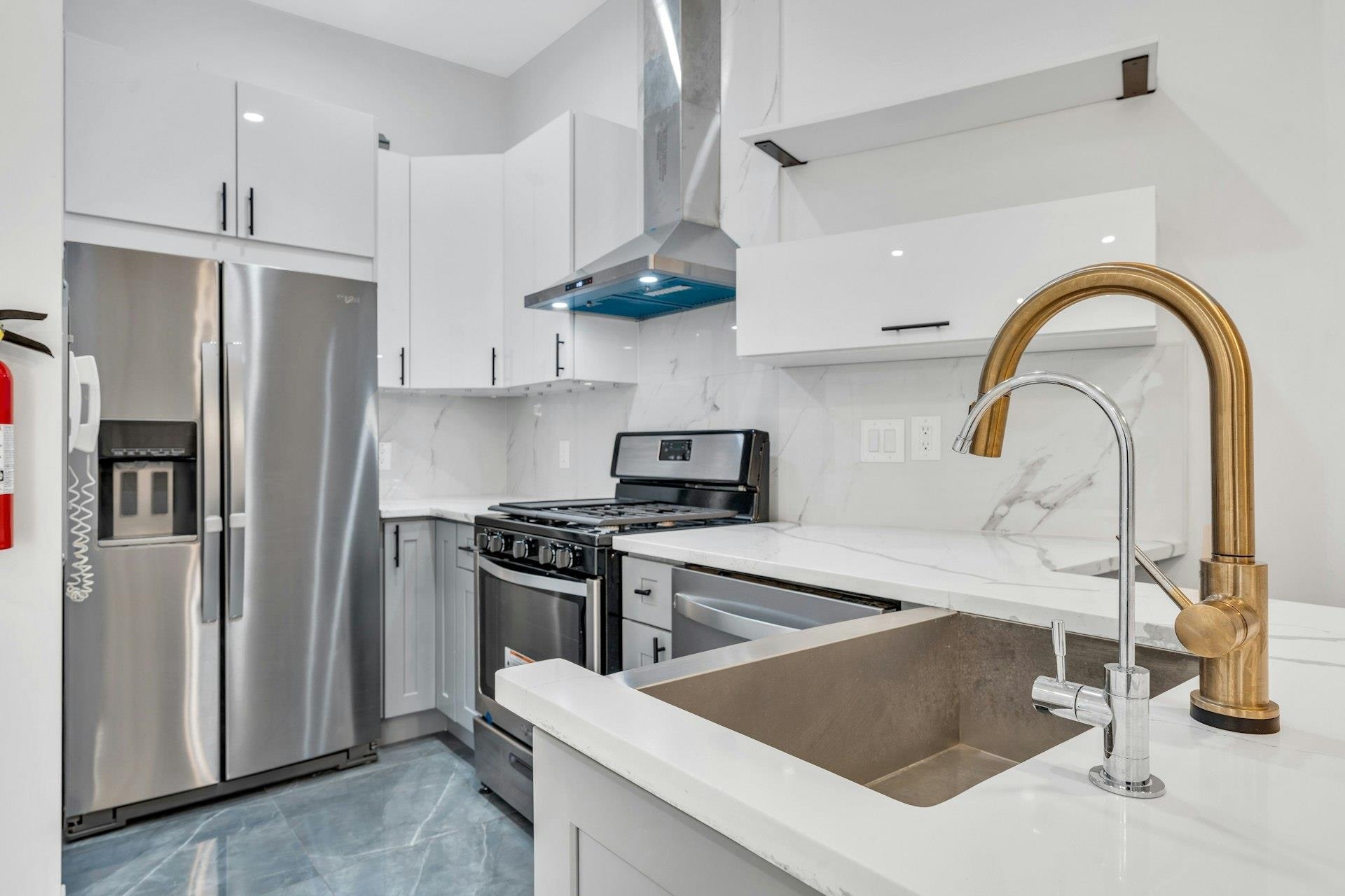 202 48th Street, Unit 3 Union City, NJ 07087 - Photo 6 of 17 a kitchen with stainless steel appliances granite countertop a sink a stove and a refrigerator