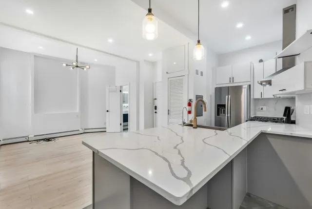 a kitchen with stainless steel appliances sink refrigerator and microwave