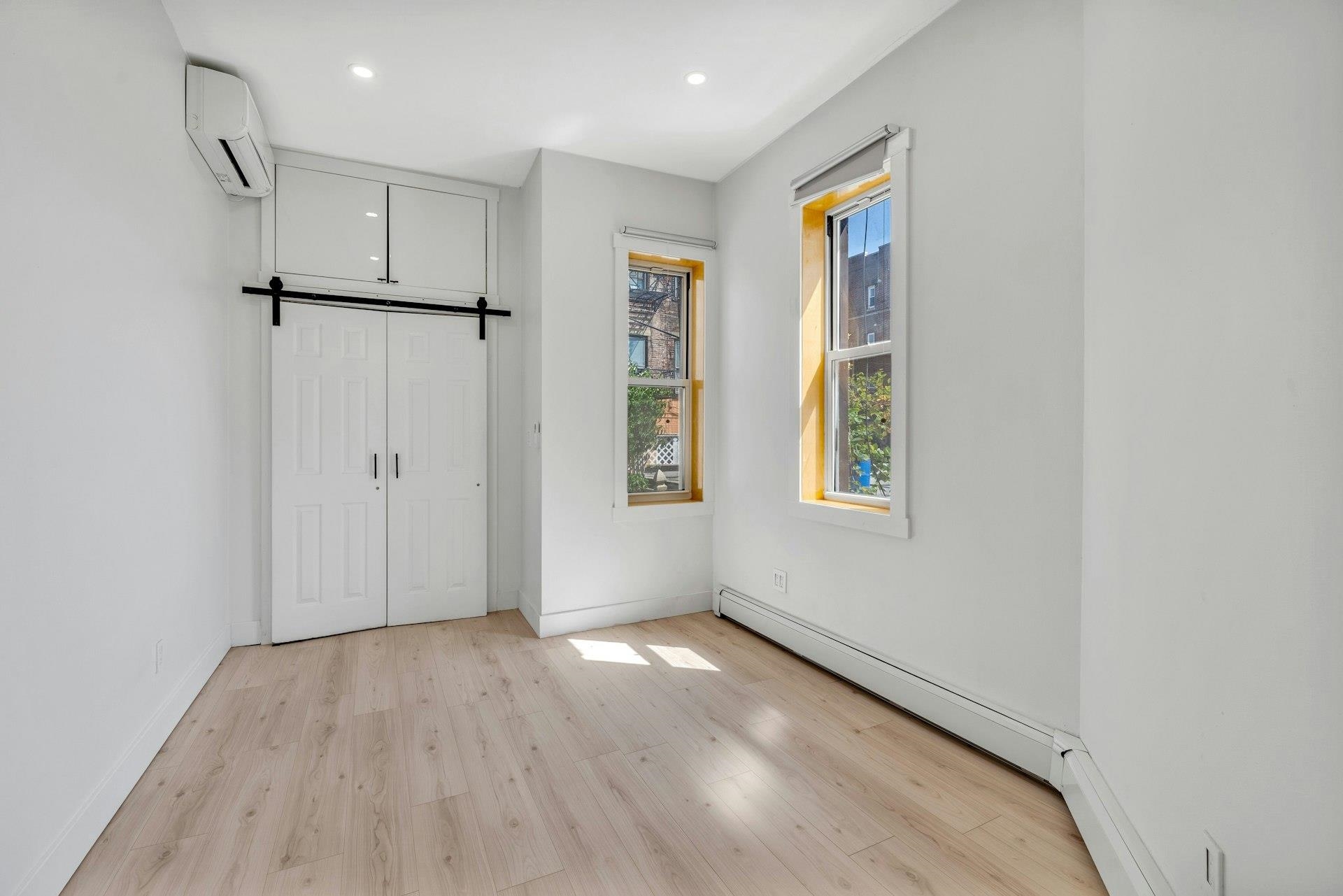 202 48th Street, Unit 3 Union City, NJ 07087 - Photo 8 of 17 a view of empty room with wooden floor and window