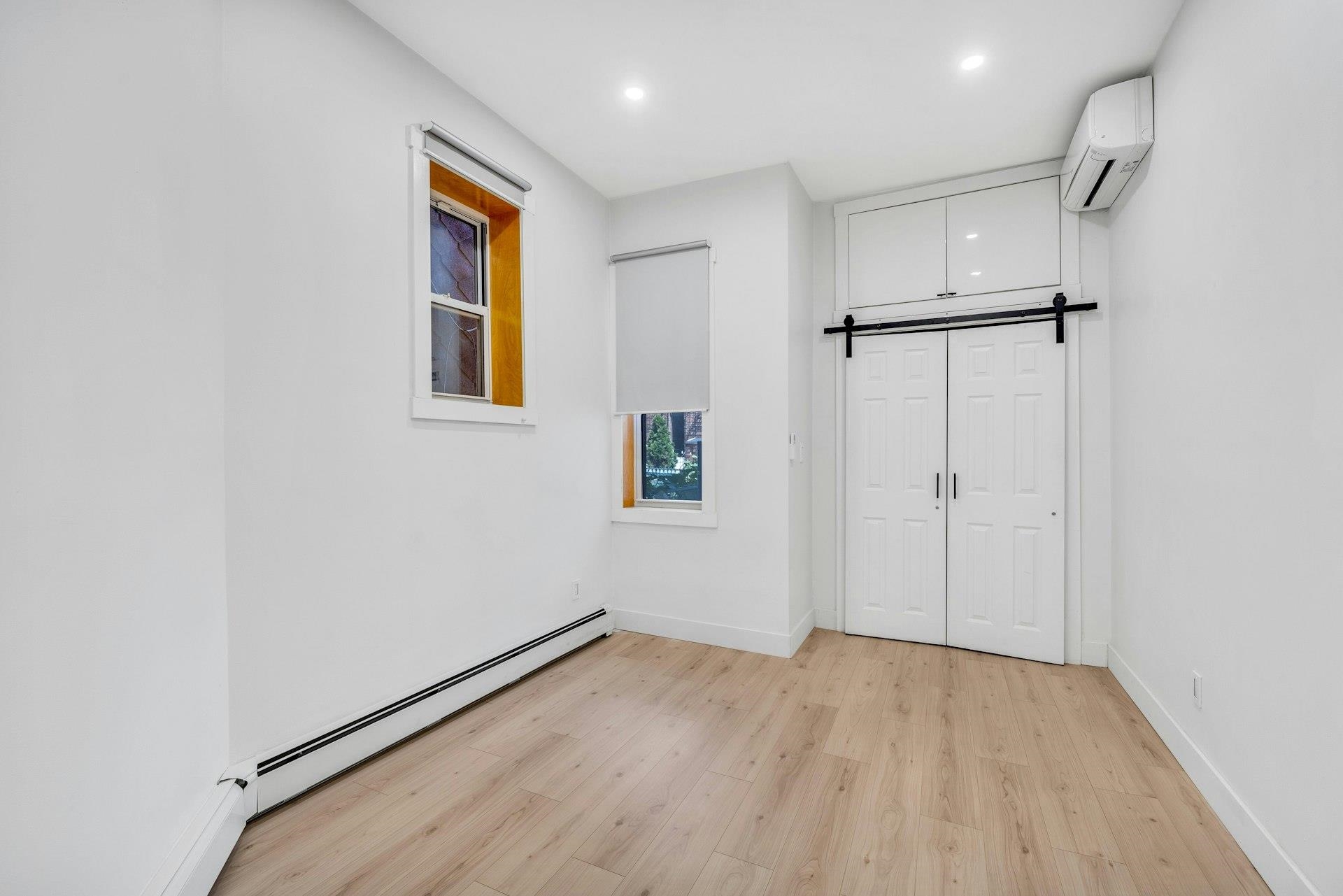 202 48th Street, Unit 3 Union City, NJ 07087 - Photo 10 of 17 a view of an empty room with wooden floor