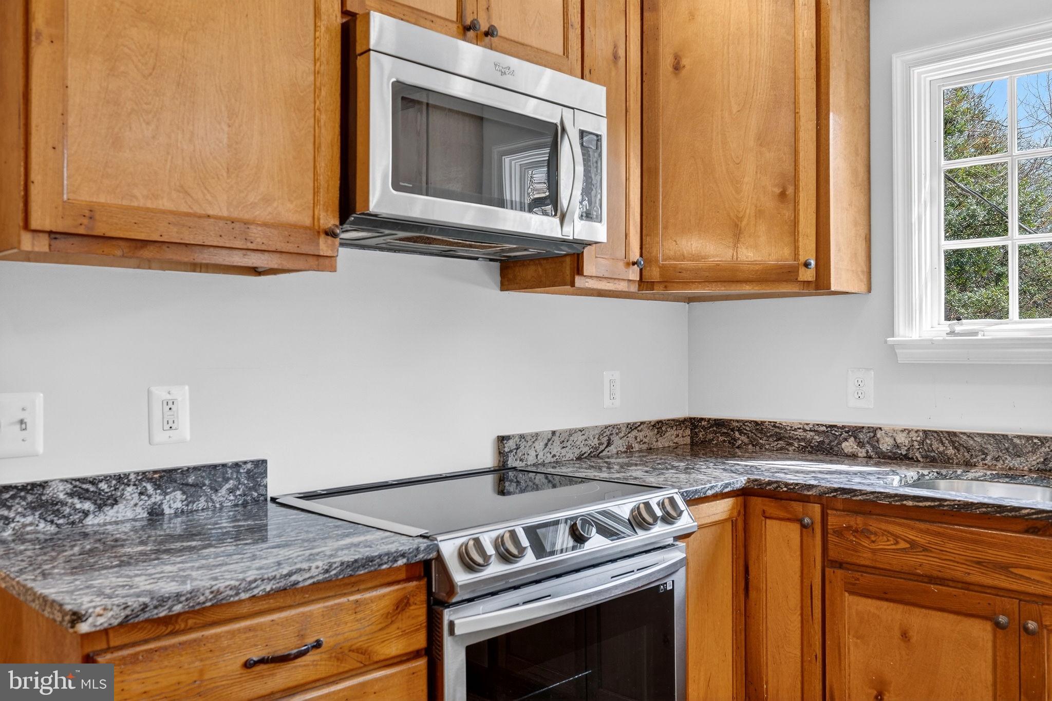 19635 Eagle Mill Road Parkton, MD 21120 - Photo 18 of 86 a kitchen with granite countertop a stove and a microwave