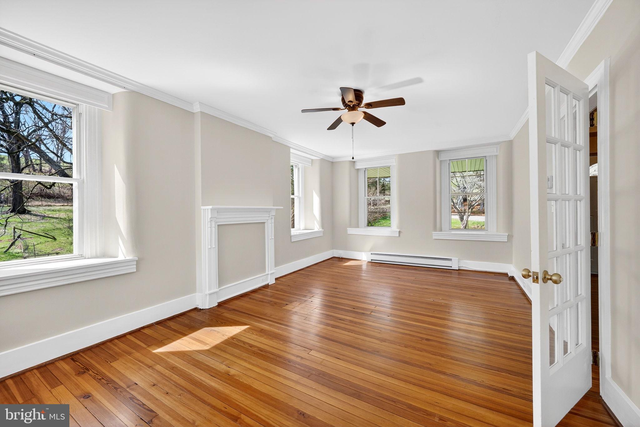 19635 Eagle Mill Road Parkton, MD 21120 - Photo 26 of 86 a view of empty room with wooden floor and fan