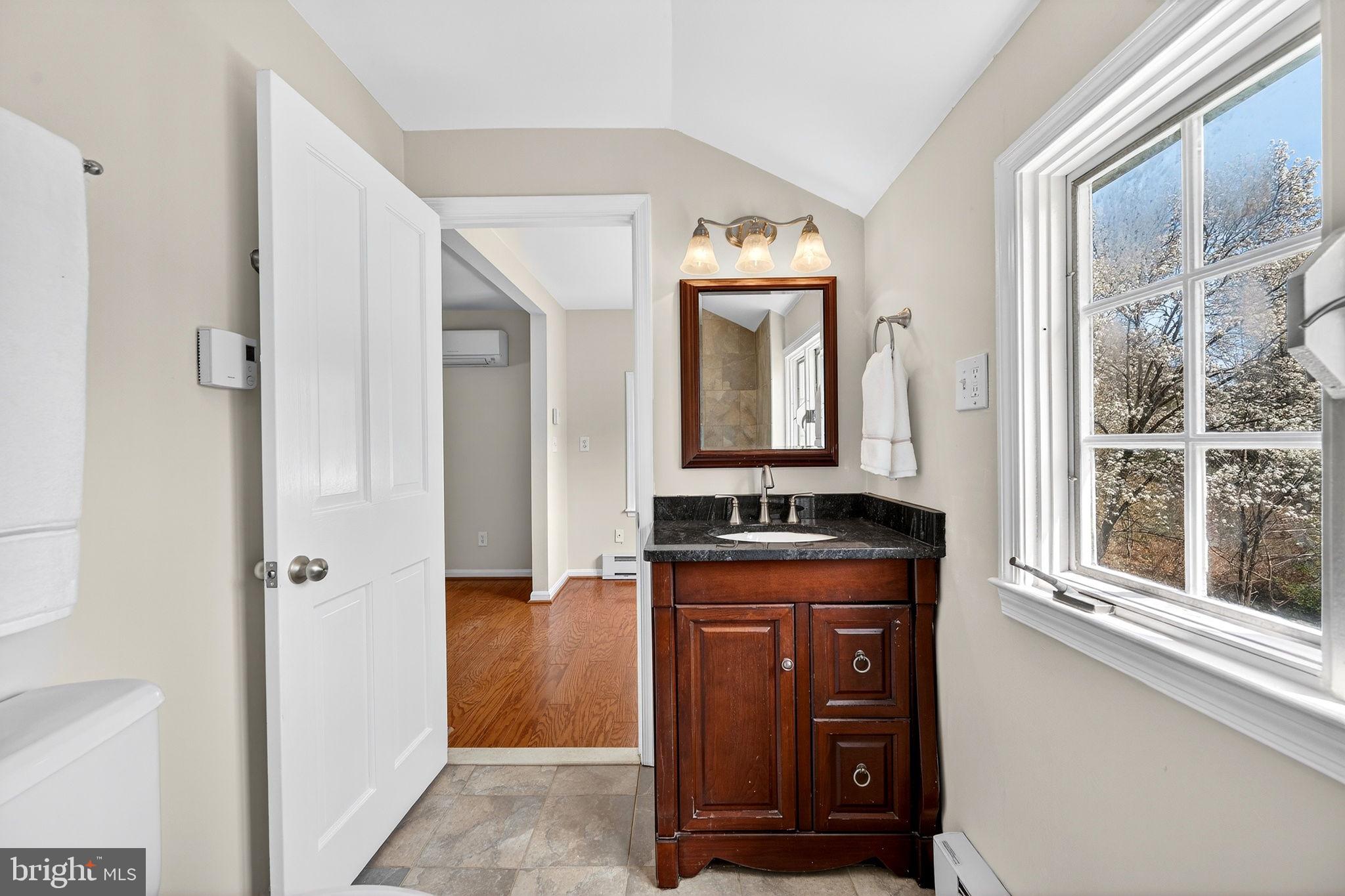 19635 Eagle Mill Road Parkton, MD 21120 - Photo 33 of 86 a bathroom with a granite countertop sink a mirror and a shower