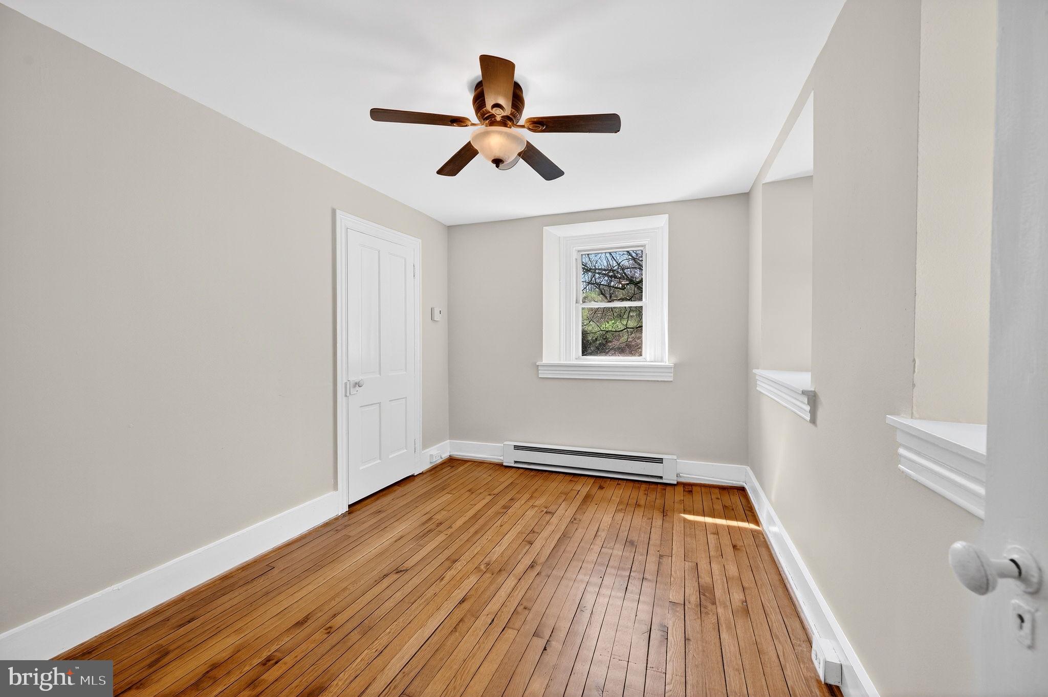 19635 Eagle Mill Road Parkton, MD 21120 - Photo 40 of 86 a view of empty room with wooden floor and fan