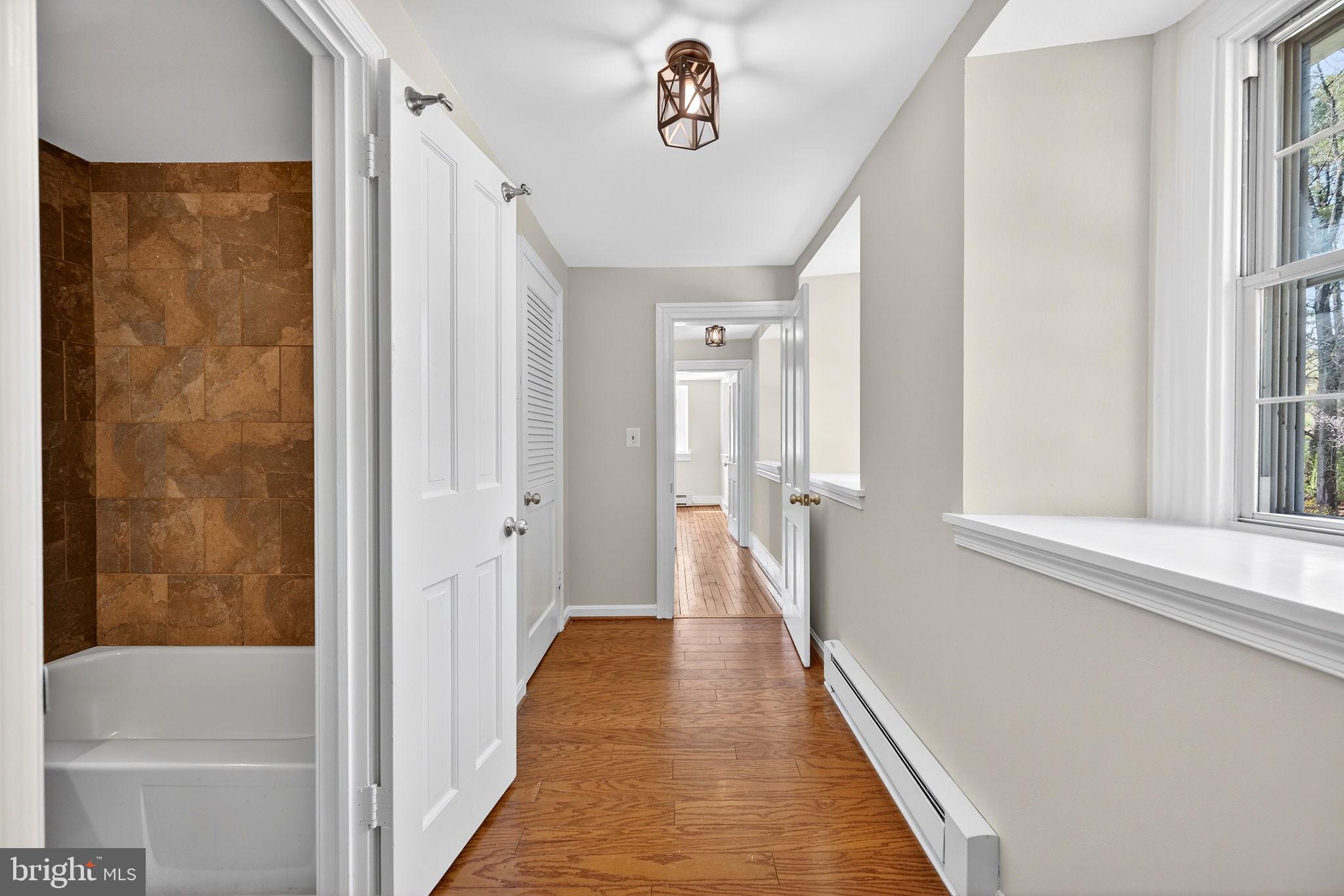 19635 Eagle Mill Road Parkton, MD 21120 - Photo 41 of 86 a view of a hallway with wooden floor and staircase