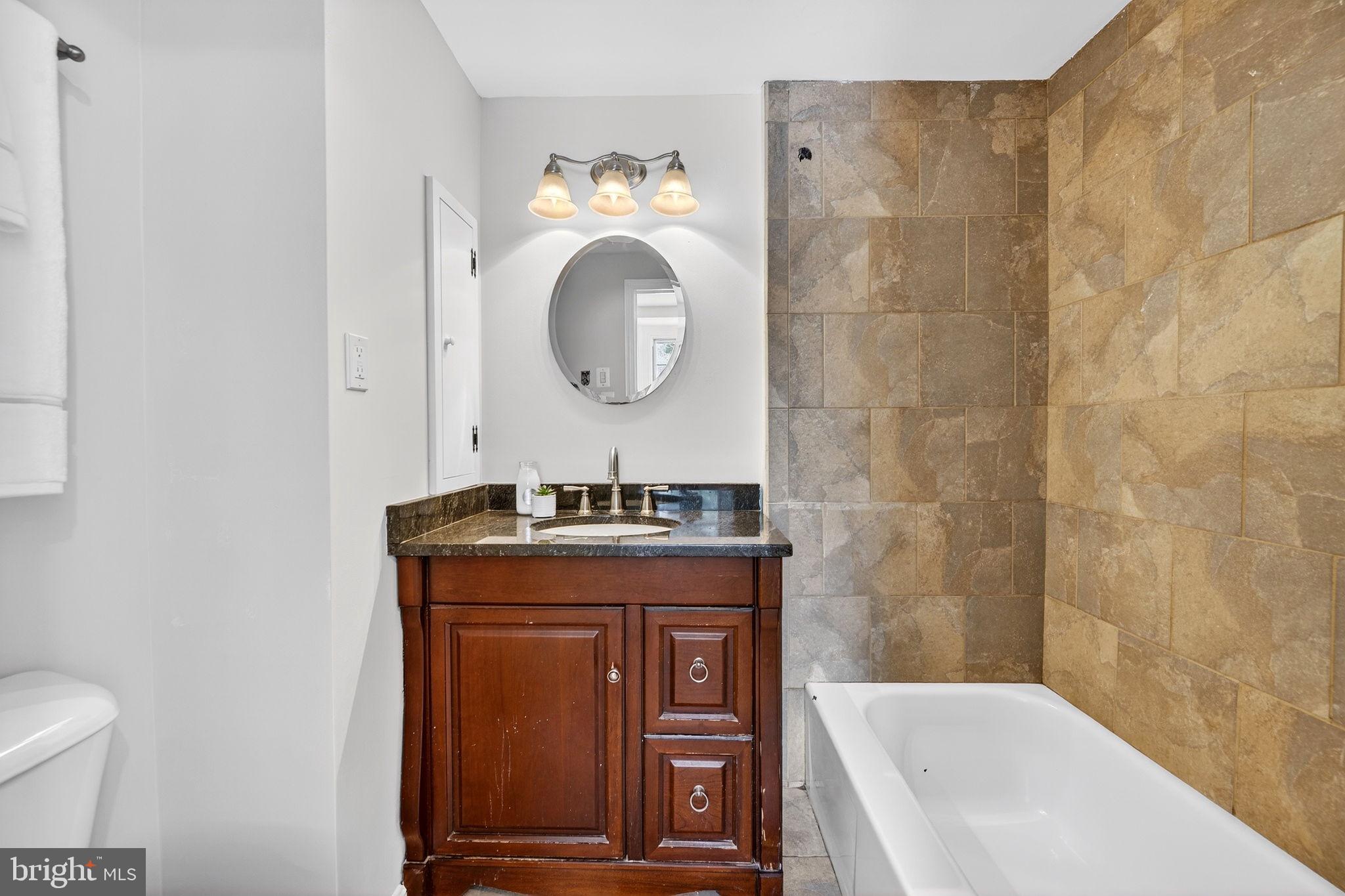 19635 Eagle Mill Road Parkton, MD 21120 - Photo 42 of 86 a bathroom with a granite countertop bathtub sink vanity mirror and toilet