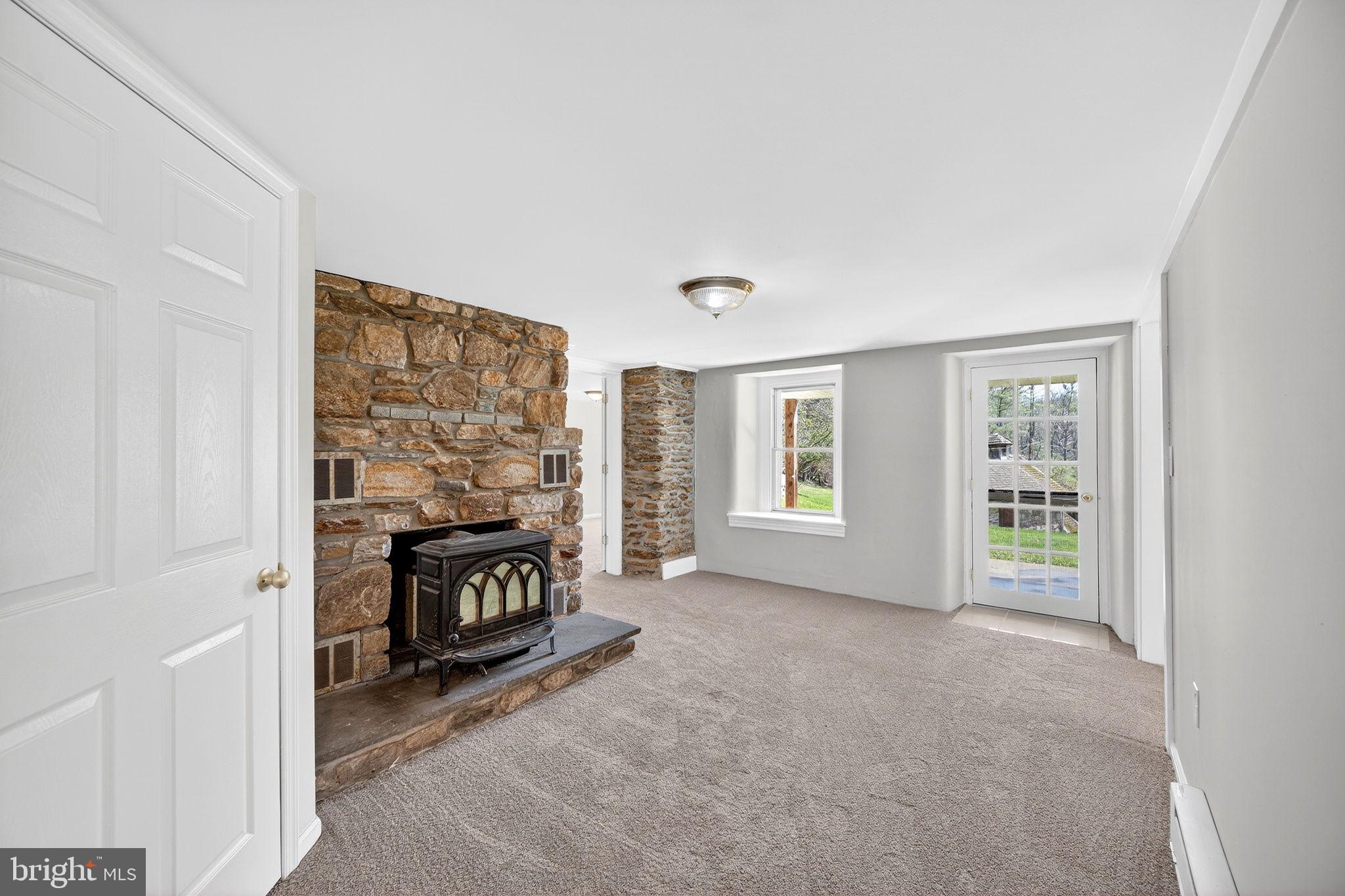19635 Eagle Mill Road Parkton, MD 21120 - Photo 50 of 86 a view of an empty room with a fireplace and a window