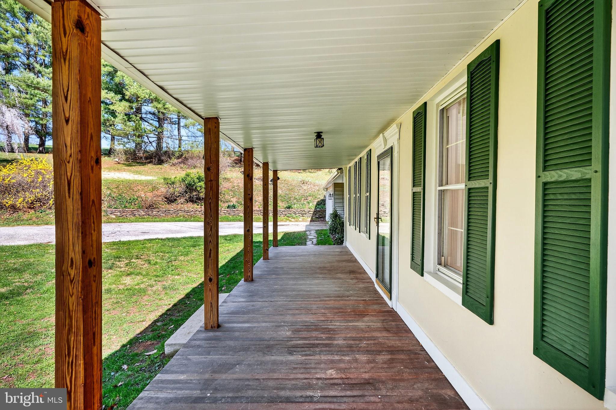 19635 Eagle Mill Road Parkton, MD 21120 - Photo 70 of 86 a view of a porch with wooden floor and stairs