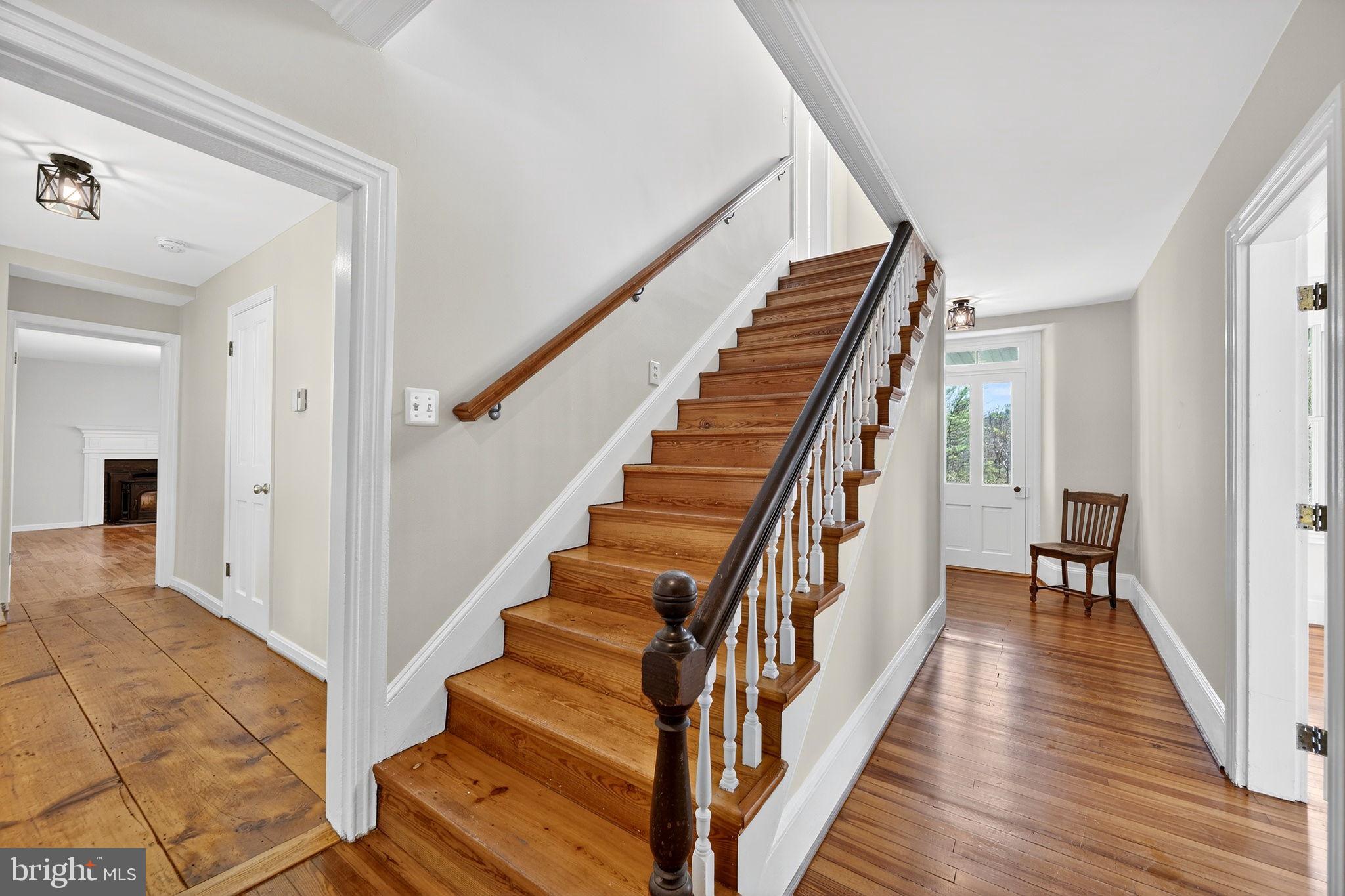19635 Eagle Mill Road Parkton, MD 21120 - Photo 8 of 86 a view of a hallway with wooden floor and staircase