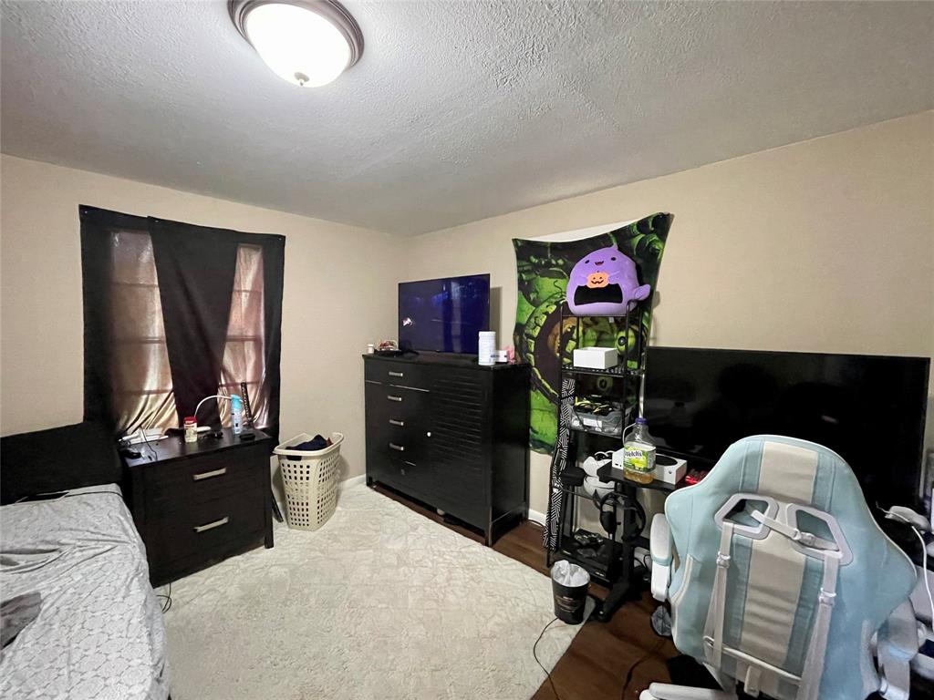 10806 Newson Road Keithville, LA 71047 - Photo 15 of 24 a bedroom with a bed and dresser