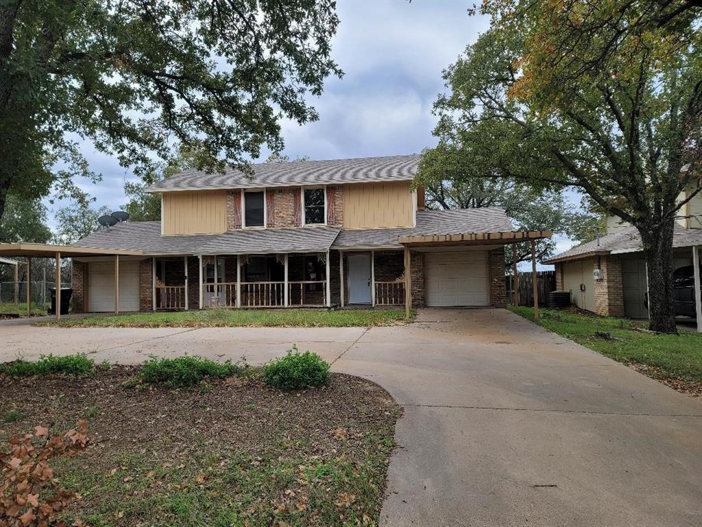 133 Lori Drive, Unit A & B Mineral Wells, TX 76067 - Photo 1 of 15 a front view of a house with a garden