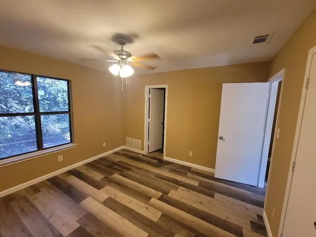 a view of room with window and ceiling fan