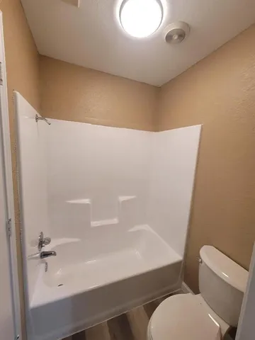 a bathroom with a toilet and a tub