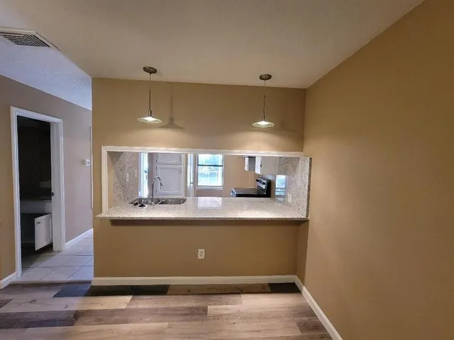 a view of kitchen with wooden floor