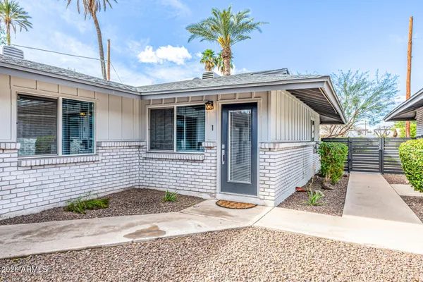 a view of a brick house with plants