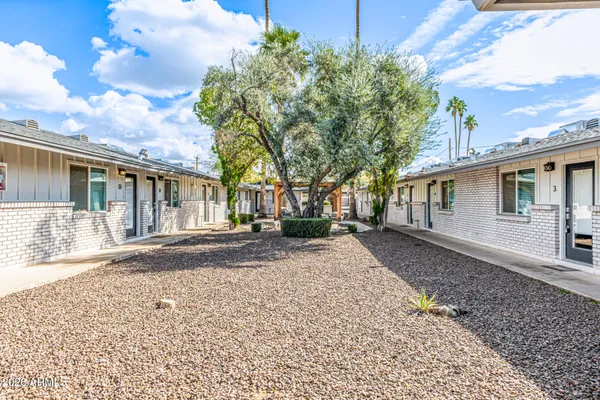 front view of a house with a tree in the background