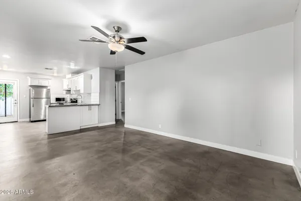 a view of a kitchen with a sink and stainless steel appliances