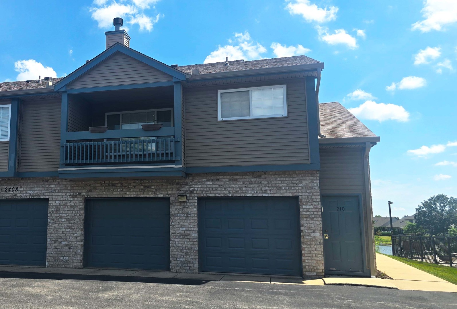 2408 Windward Boulevard, Unit 106 Champaign, IL 61821 - Photo 1 of 17 a front view of a house with yard