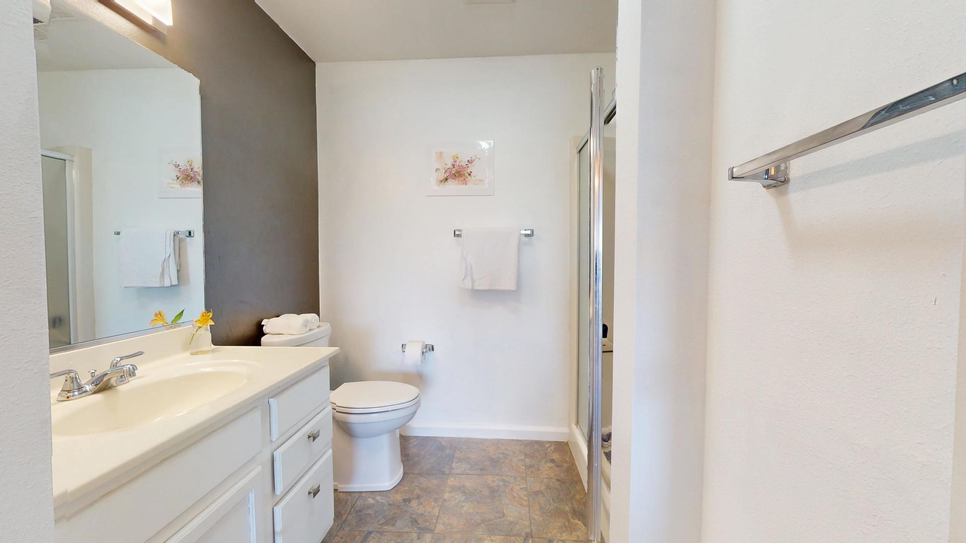 2408 Windward Boulevard, Unit 106 Champaign, IL 61821 - Photo 11 of 17 a bathroom with a sink a toilet and shower