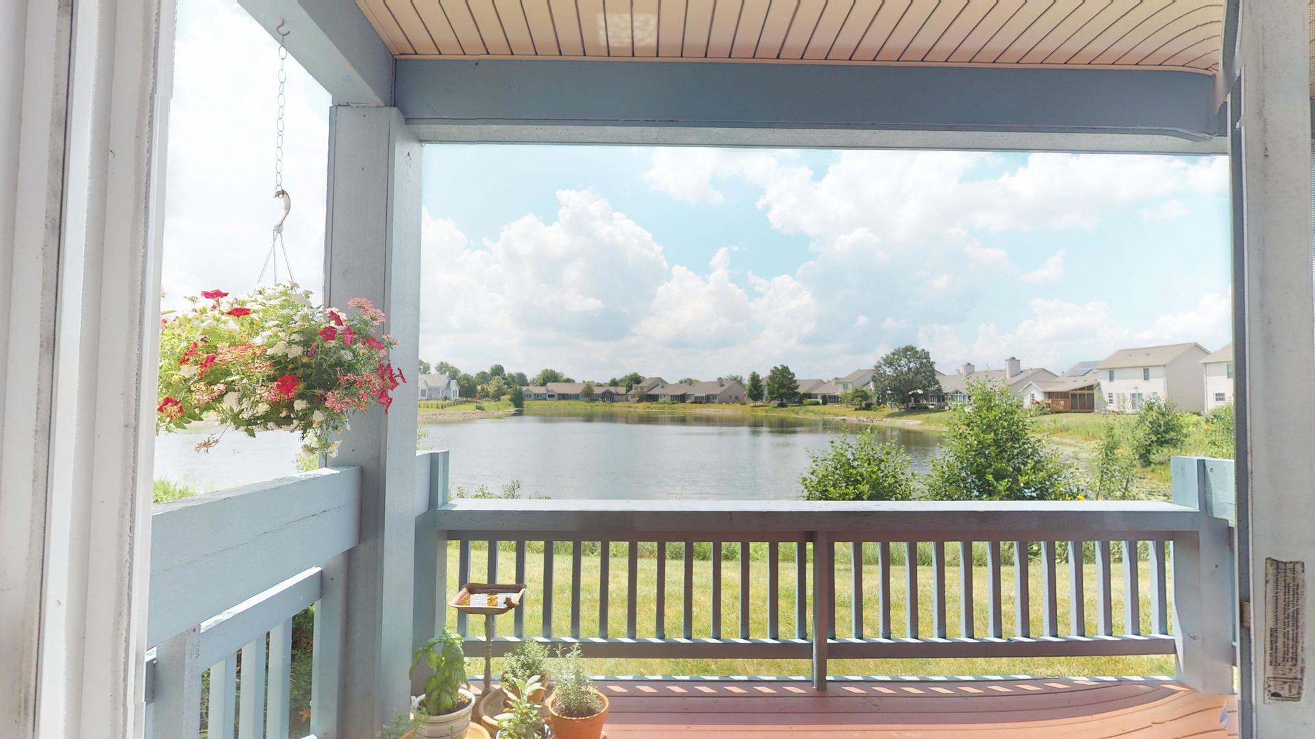 2408 Windward Boulevard, Unit 106 Champaign, IL 61821 - Photo 13 of 17 a view of a lake from a balcony