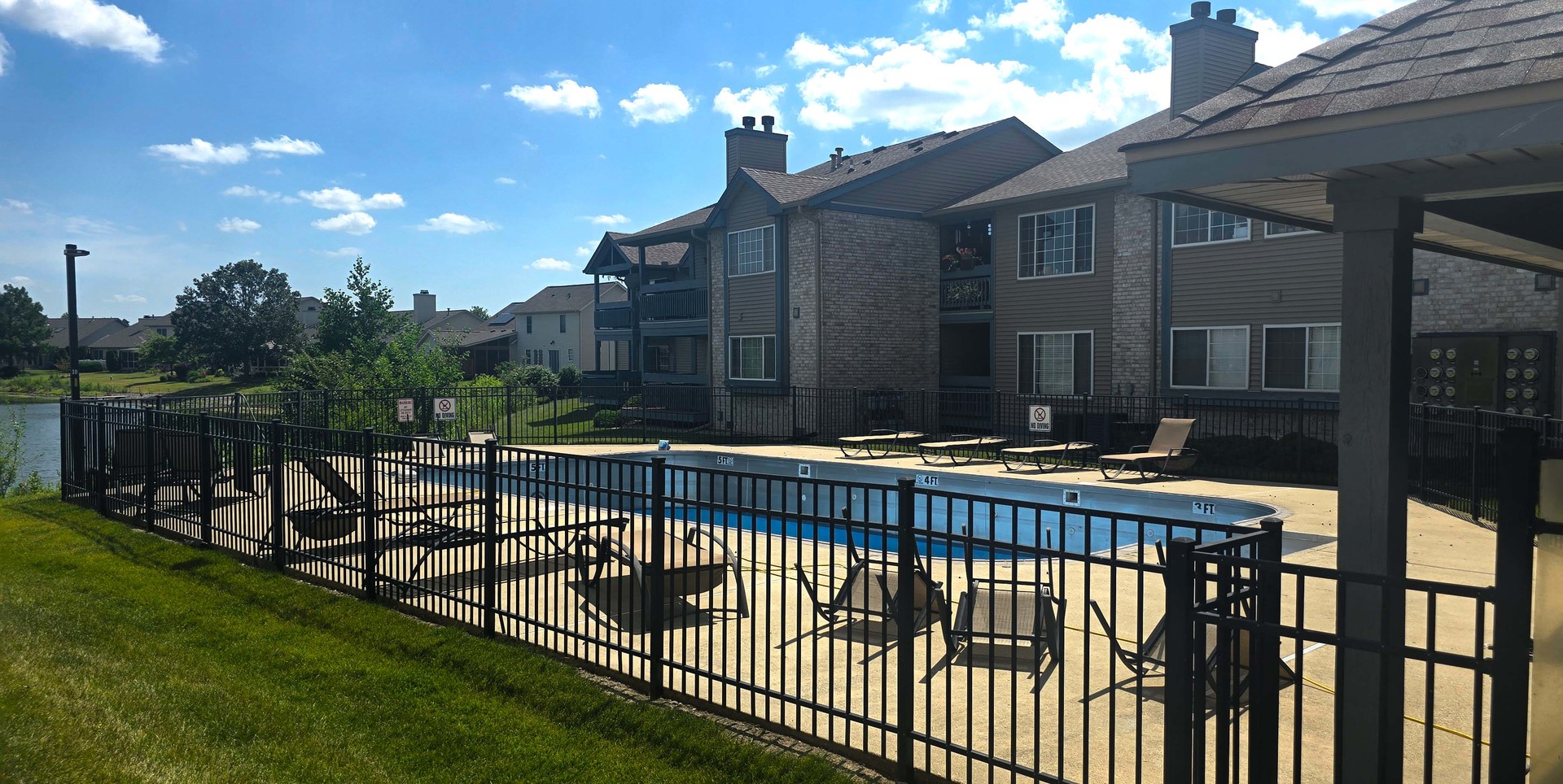 2408 Windward Boulevard, Unit 106 Champaign, IL 61821 - Photo 14 of 17 a view of a roof deck with table and chairs with wooden fence