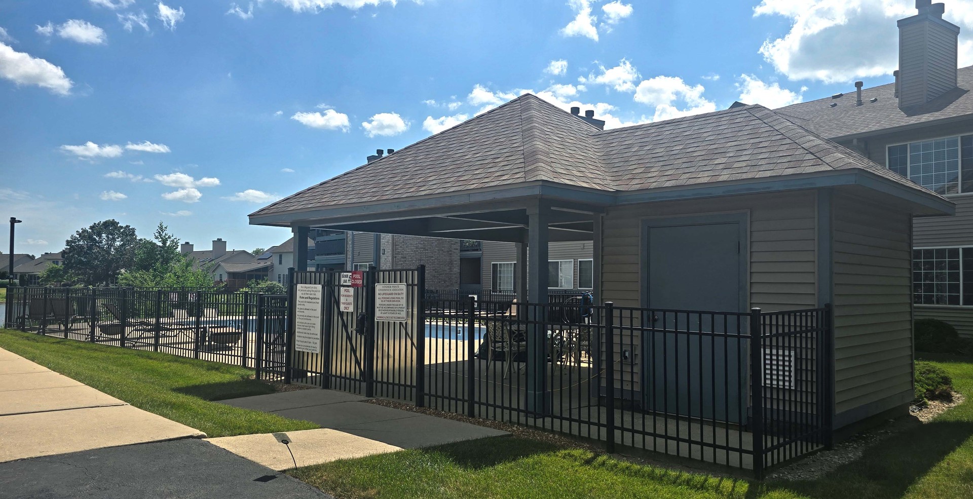 2408 Windward Boulevard, Unit 106 Champaign, IL 61821 - Photo 15 of 17 a view of a house with iron fence