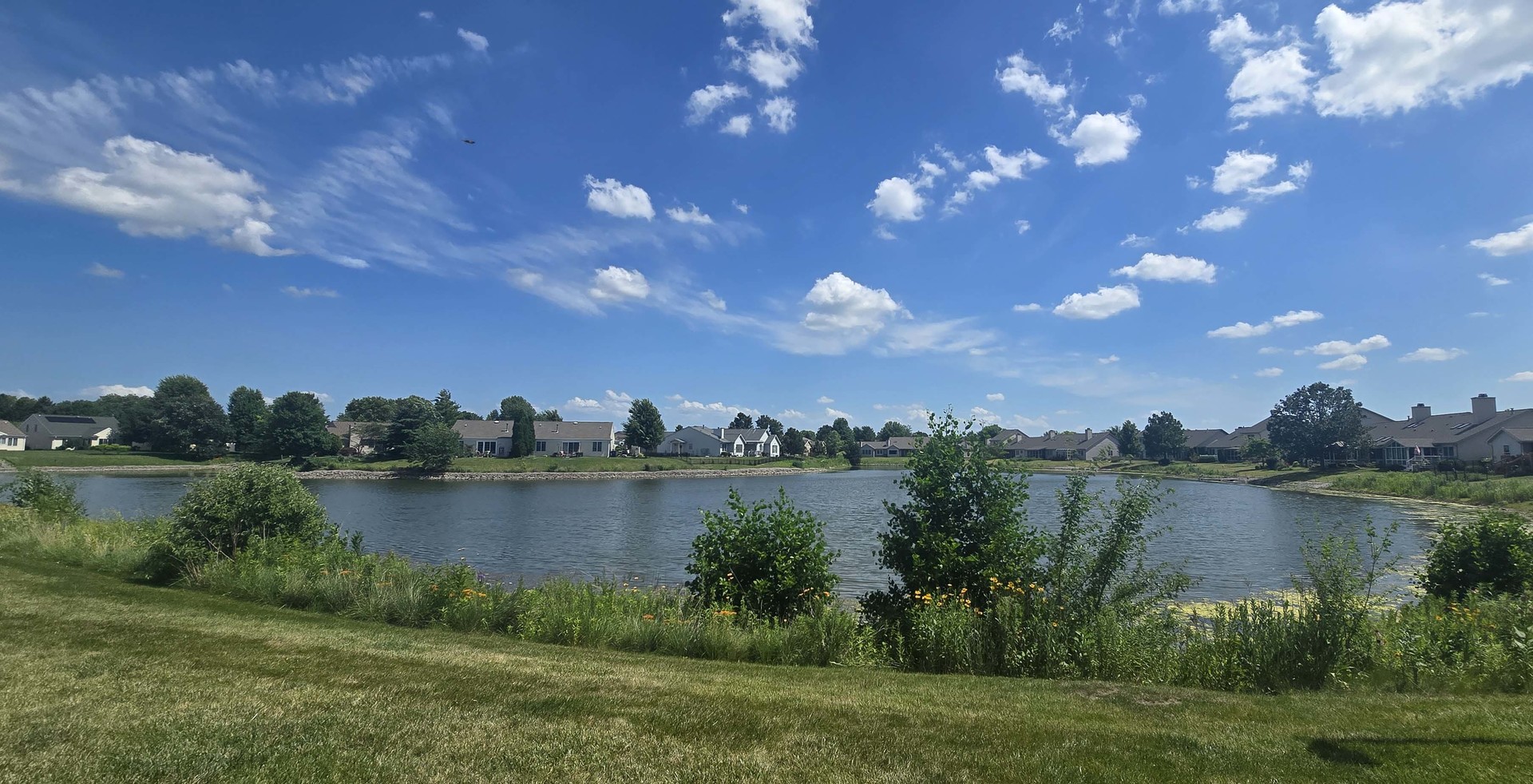 2408 Windward Boulevard, Unit 106 Champaign, IL 61821 - Photo 16 of 17 a view of a lake with houses in the back