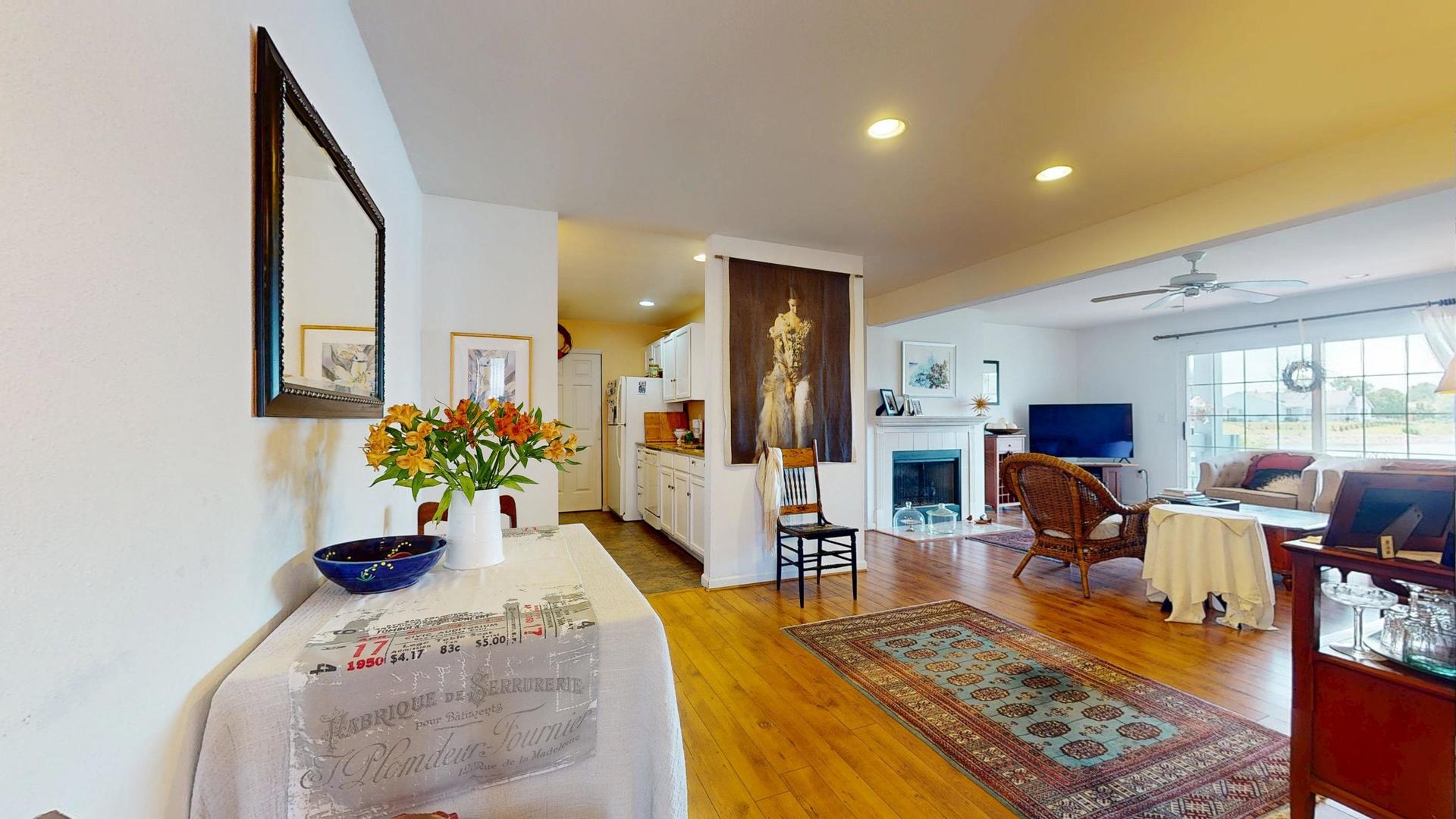 2408 Windward Boulevard, Unit 106 Champaign, IL 61821 - Photo 2 of 17 a living room with furniture and a chandelier