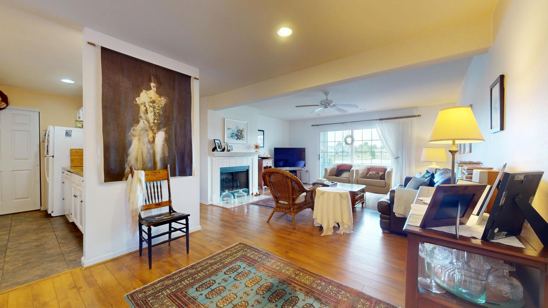 2408 Windward Boulevard, Unit 106 Champaign, IL 61821 - Photo 3 of 17 a living room with furniture and a flat screen tv