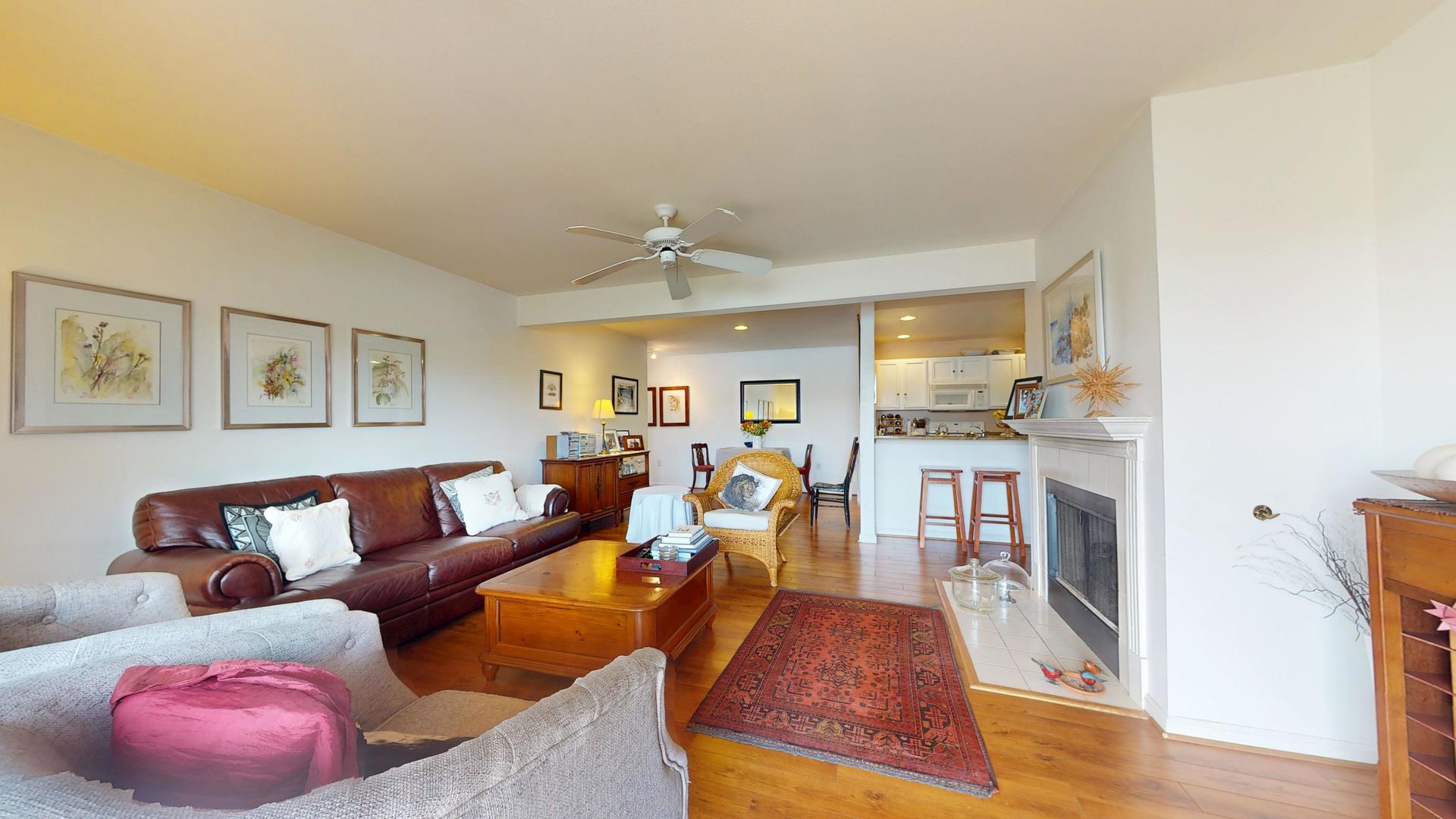 2408 Windward Boulevard, Unit 106 Champaign, IL 61821 - Photo 5 of 17 a living room with furniture and a wooden floor