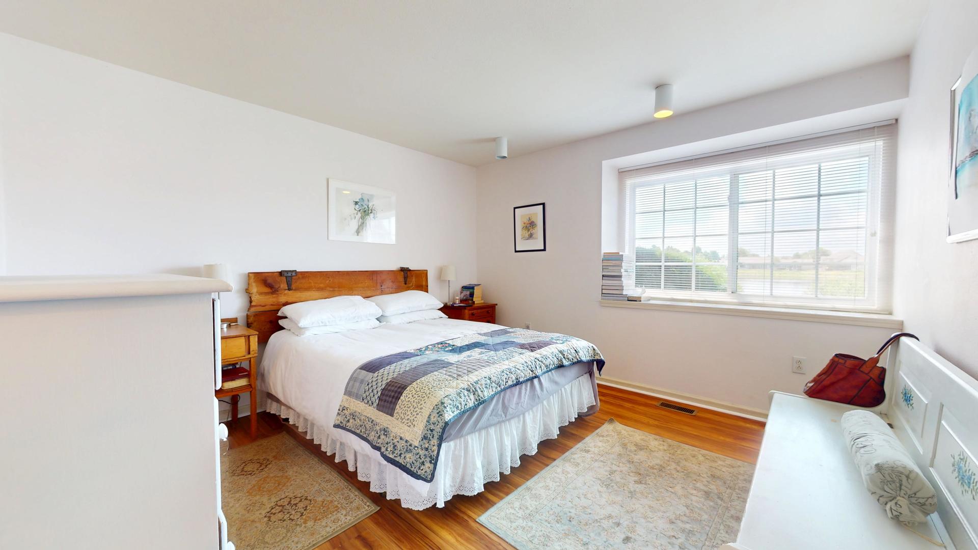 2408 Windward Boulevard, Unit 106 Champaign, IL 61821 - Photo 6 of 17 a bedroom with a bed and window