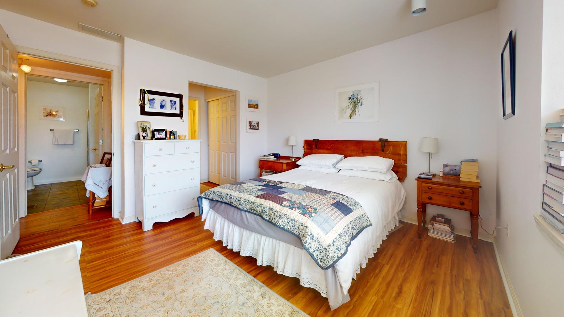 2408 Windward Boulevard, Unit 106 Champaign, IL 61821 - Photo 9 of 17 a bedroom with a bed and a table in it