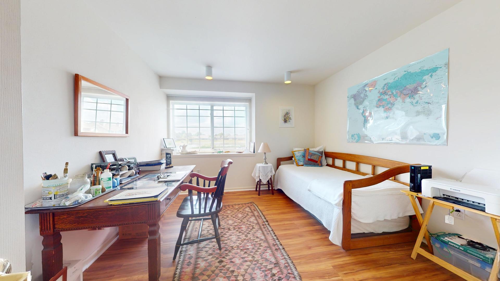 2408 Windward Boulevard, Unit 106 Champaign, IL 61821 - Photo 10 of 17 a bedroom with a bed and wooden floor