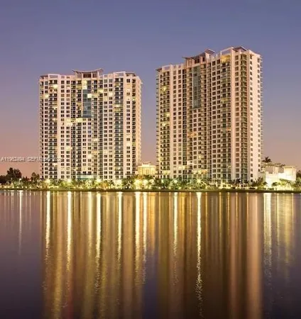 a view of a large building next to a lake