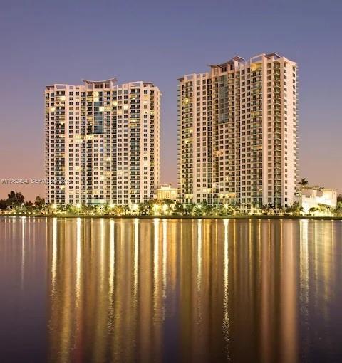 a view of a large building next to a lake