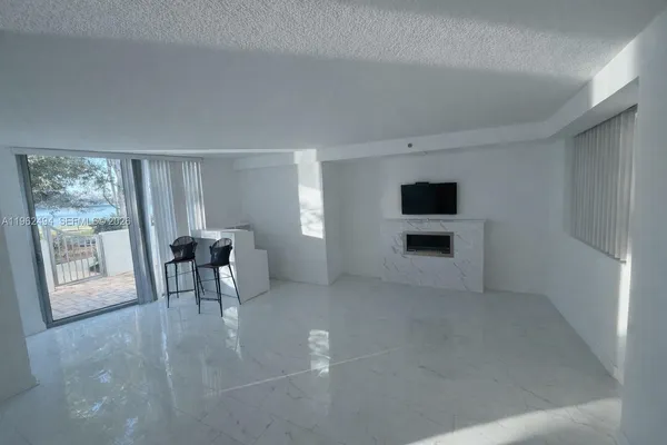 a view of a livingroom with furniture and a fireplace