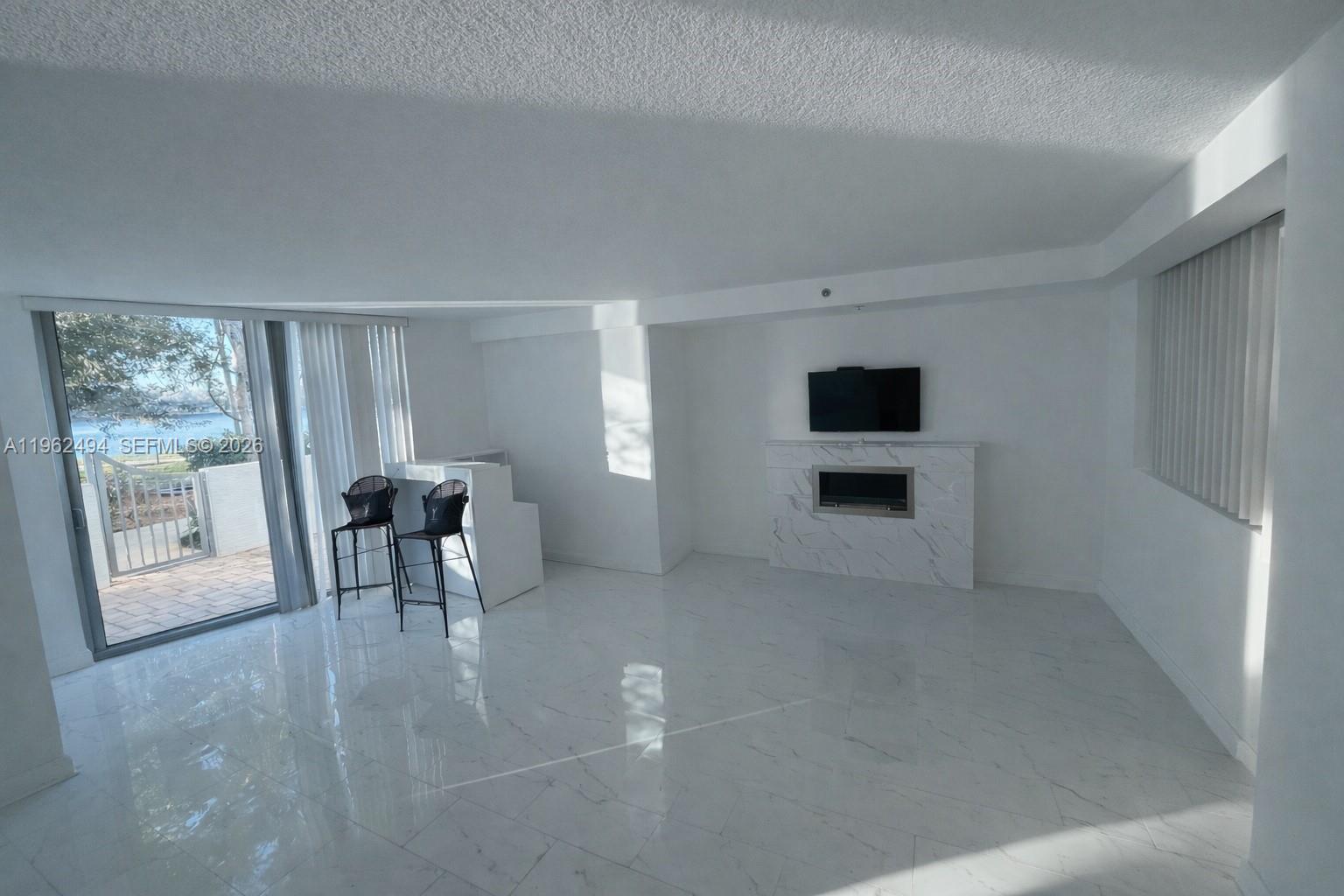 2641 North Flamingo Road, Unit TH5N Sunrise, FL 33323 - Photo 12 of 12 a view of a livingroom with furniture and a fireplace