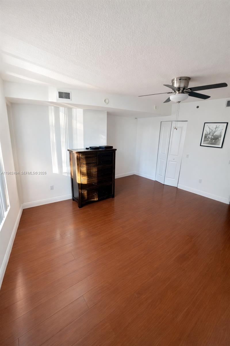2641 North Flamingo Road, Unit TH5N Sunrise, FL 33323 - Photo 7 of 12 an empty room with windows and cabinet