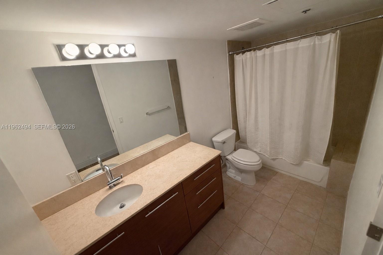2641 North Flamingo Road, Unit TH5N Sunrise, FL 33323 - Photo 8 of 12 a bathroom with a sink a toilet and shower