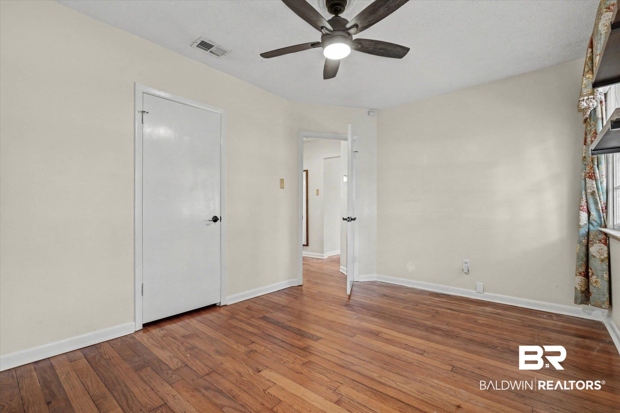 5117 Norton Lane Mobile, AL 36608 - Photo 15 of 35 Unfurnished bedroom featuring hardwood / wood-style flooring and ceiling fan