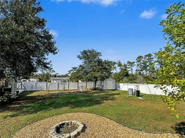 a view of a house with a backyard