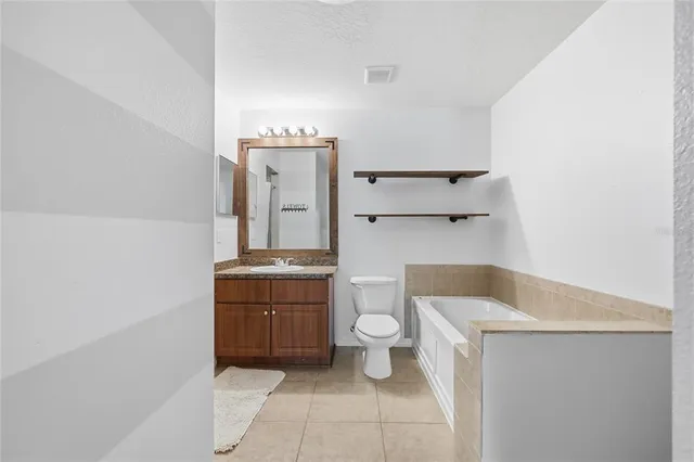a bathroom with a sink toilet and mirror