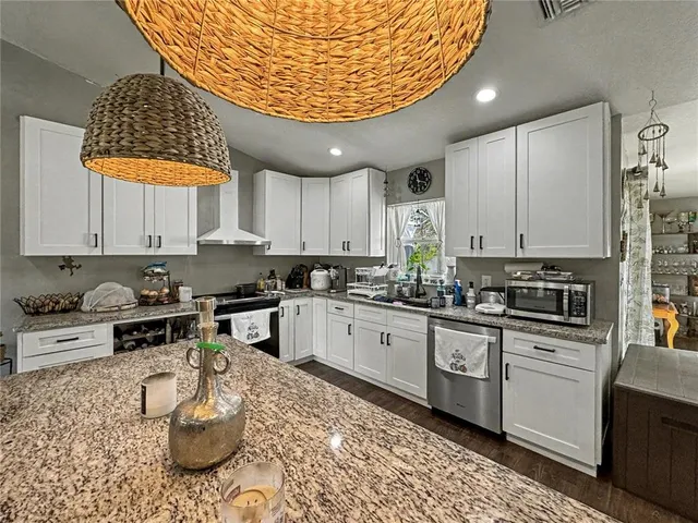 a kitchen with a sink a stove and cabinets