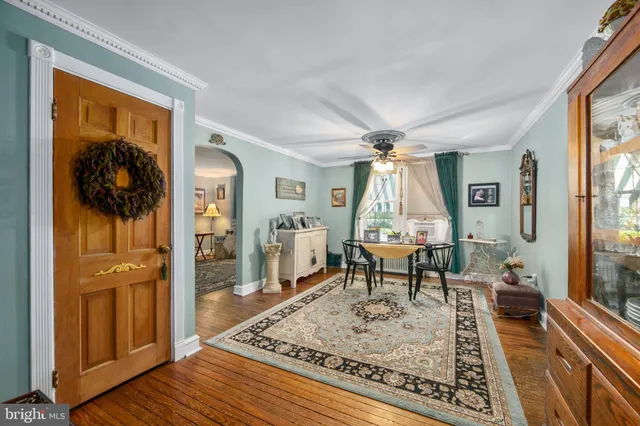 a living room with furniture a flat screen tv and kitchen view