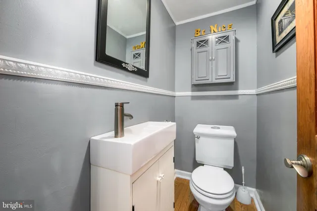 a kitchen with stainless steel appliances granite countertop a refrigerator a stove a sink and dishwasher with wooden floor